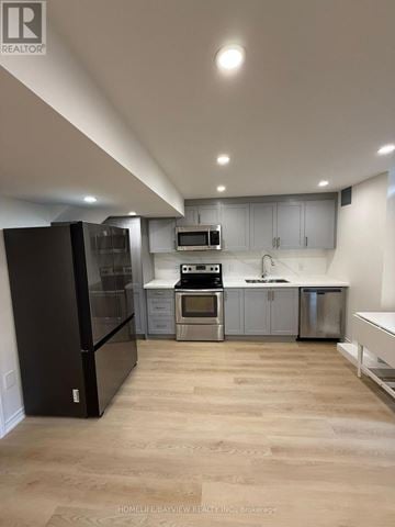 Georgina (Keswick South) apartment for rent - A modern kitchen with wooden floors and stainless steel appliances.