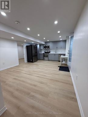 Georgina (Keswick South) apartment for rent - A spacious kitchen with wooden flooring and white walls.
