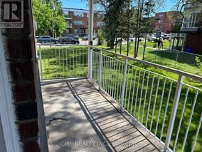 Toronto (Stonegate-Queensway) condo for rent - A white fence leads to a green lawn.