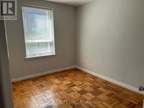 Toronto (Stonegate-Queensway) condo for rent - A room with a window and wooden flooring.