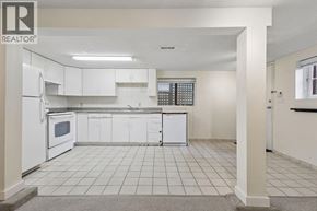 Vancouver apartment for rent - A white kitchen with a refrigerator, microwave, and cabinets.