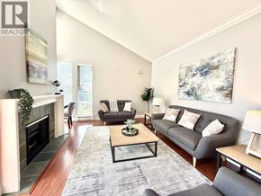 Vancouver apartment for rent - A living room with a grey couch, a coffee table, and a fireplace.