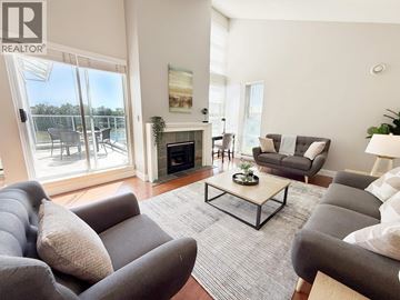 Vancouver apartment for rent - A living room with grey couches and a fireplace.
