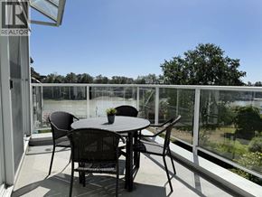 Vancouver apartment for rent - A patio with a table and chairs overlooking a body of water.