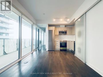 Toronto (Church-Yonge Corridor) condo for rent - A spacious kitchen with wooden floors and a large window.