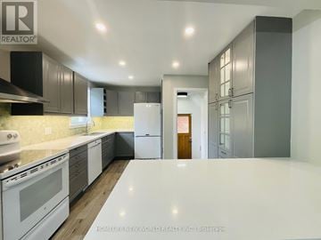 Toronto (Wexford-Maryvale) apartment for rent - A kitchen with white appliances and wooden floors.