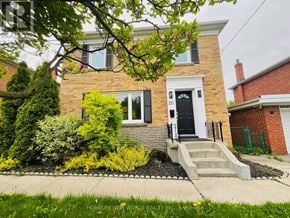 Toronto (Wexford-Maryvale) apartment for rent - A brick house with a black front door and a small front yard.