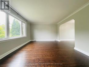Toronto (Wexford-Maryvale) apartment for rent - A room with wooden floors and white walls, with a window on the left side.