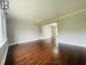 Toronto (Wexford-Maryvale) apartment for rent - A room with wooden floors and white walls, with a window on the left side.