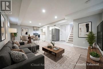 Oshawa (Central) duplex for rent - A well-lit, modern living room with a grey sofa and a wooden coffee table.