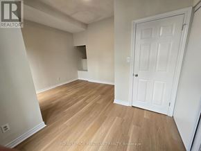 Toronto (University) apartment for rent - A room with wooden flooring and a white door.