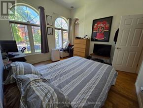 Toronto (Annex) multi-family for rent - A bedroom with a bed, a desk, and a window.