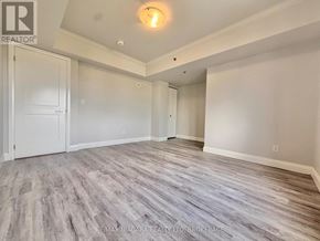 Niagara Falls (Hospital) condo for rent - A room with a wooden floor and white walls.