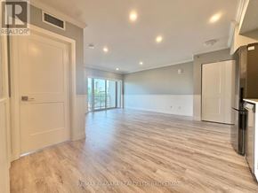 Niagara Falls (Hospital) condo for rent - A spacious room with wooden flooring and a large window.
