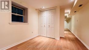 Toronto (Annex) townhouse for rent - A white door with a window above it in a room with wooden floors.
