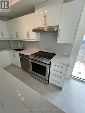 Vaughan (Vellore Village) condo for rent - A modern kitchen with white cabinets and stainless steel appliances.