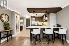 Markham (Unionville) condo for rent - A modern kitchen with a dining table set for four.