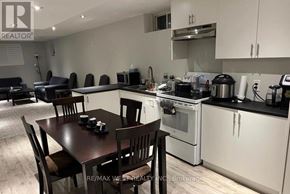 Richmond Hill (Oak Ridges Lake Wilcox) apartment for rent - A kitchen with a table and chairs in the foreground and a stove top oven in the background.