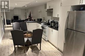 Richmond Hill (Oak Ridges Lake Wilcox) apartment for rent - A modern kitchen with a dining table set for four.