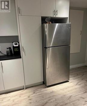Richmond Hill (Oak Ridges Lake Wilcox) apartment for rent - A stainless steel refrigerator in a kitchen with white cabinets.