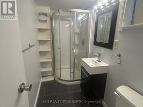 Barrie (Sanford) apartment for rent - A bathroom with a sink, toilet and shower.