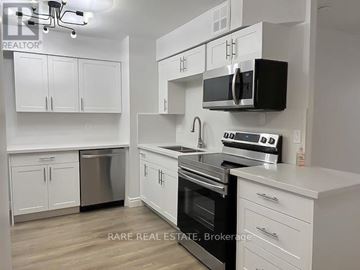 Mississauga (City Centre) condo for rent - A kitchen with white cabinets and a black microwave.