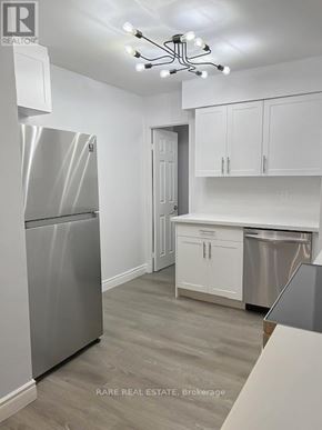 Mississauga (City Centre) condo for rent - A kitchen with a stainless steel refrigerator and cabinets.
