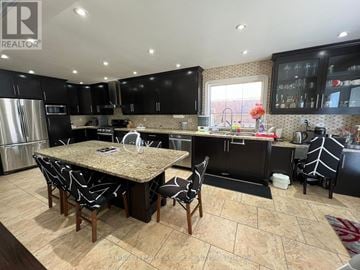Brampton (Fletcher's Meadow) apartment for rent - A kitchen with a table and chairs in the middle of it.