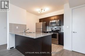 Toronto (Dovercourt-Wallace Emerson-Junction) condo for rent - A kitchen with a granite countertop and stainless steel appliances.