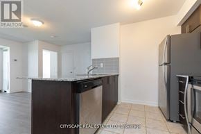 Toronto (Dovercourt-Wallace Emerson-Junction) condo for rent - A kitchen with a refrigerator, sink, and cabinets.