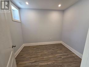 Toronto (Downsview-Roding-Cfb) apartment for rent - A room with wooden flooring and white walls.