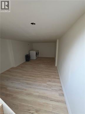 Guelph apartment for rent - A room with wooden flooring and white walls.