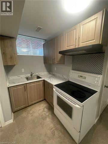 Guelph apartment for rent - A white oven and sink in a kitchen.