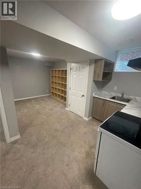 Guelph apartment for rent - A kitchen area with a washing machine and a cabinet.