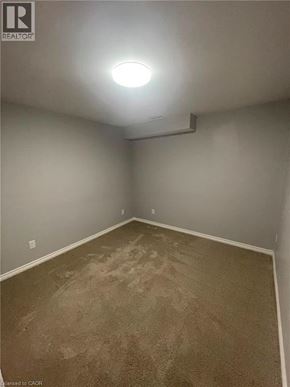Guelph apartment for rent - A room with carpeted floor and a light on the ceiling.