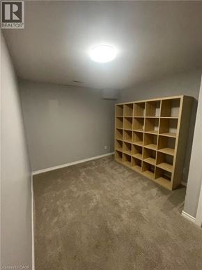 Guelph apartment for rent - A room with a shelving unit and a carpeted floor.