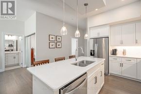 Guelph (Pineridge/Westminster Woods) condo for rent - A modern kitchen with white cabinets and a center island.
