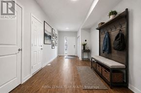 North Grenville townhouse for rent - A hallway with a bench and coat rack.