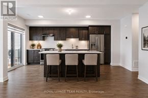 North Grenville townhouse for rent - A modern kitchen with dark wood cabinets and a center island.