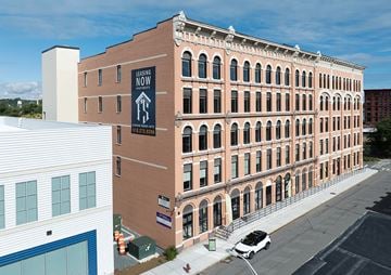 Troy apartment for rent - A large building with a sign that says "Leasing Now" is shown.