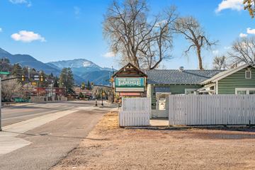 Colorado Springs apartment for rent - A road with a sign that says "Lodge" in front of a house.