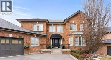 Vaughan (Islington Woods) duplex for rent - A large brick house with a black front door and a garage.