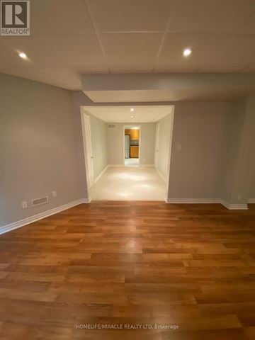 Vaughan (Islington Woods) multi-family for rent - A kitchen with wooden cabinets and a stainless steel refrigerator.