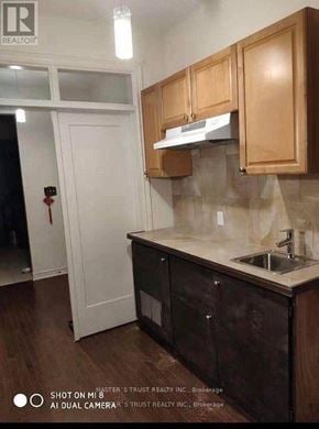 Markham (Berczy) townhouse for rent - A kitchen with wooden cabinets and a white door.