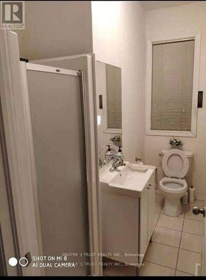 Markham (Berczy) townhouse for rent - A white bathroom with a toilet, sink, and shower.