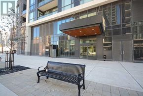 Mississauga (Creditview) condo for rent - A black bench sits in front of a glass building.
