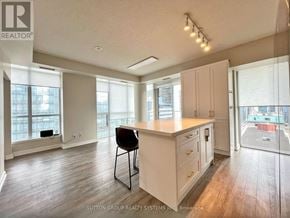 Toronto (Waterfront Communities) condo for rent - A kitchen with a white counter and a black chair.