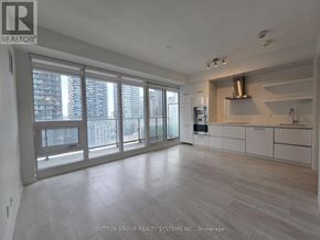 Toronto (Mount Pleasant West) condo for rent - A spacious kitchen with white cabinets and a stainless steel range hood.