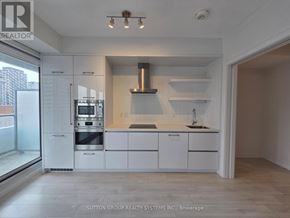 Toronto (Mount Pleasant West) condo for rent - A modern kitchen with white cabinets and a stainless steel oven.