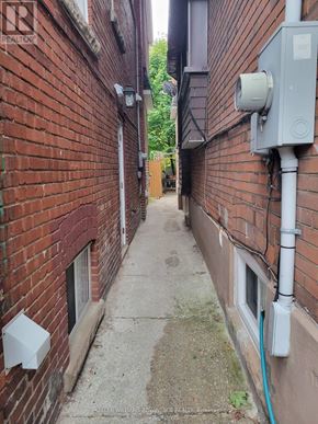 Toronto (Oakwood Village) apartment for rent - A narrow alley with a Realty sign on the wall.